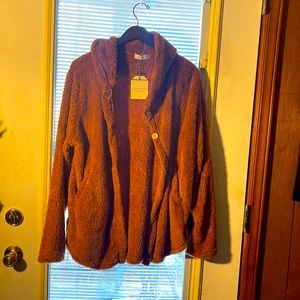 Lite weight jacket with hood. Rusted color. Buttons in front .